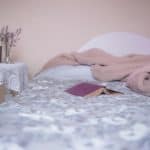 bed with book and comforter